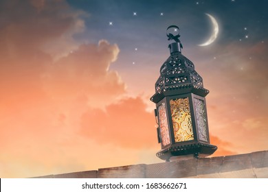 Ornamental Arabic lantern with burning candle glowing at night. Festive greeting card, invitation for Muslim holy month Ramadan Kareem. - Shutterstock ID 1683662671