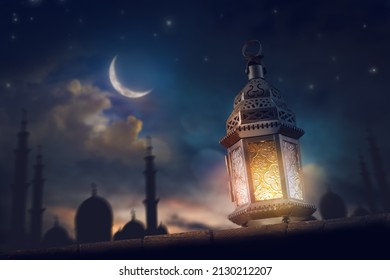 Ornamental Arabic lantern with burning candle glowing at night. Festive greeting card, invitation for Muslim holy month Ramadan Kareem. - Shutterstock ID 2130212207