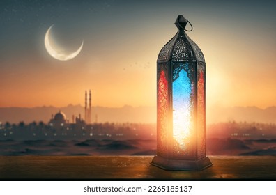 Ornamental Arabic lantern with burning candle glowing at night mosque background. Festive greeting card, invitation for Muslim holy month Ramadan Kareem. - Shutterstock ID 2265185137