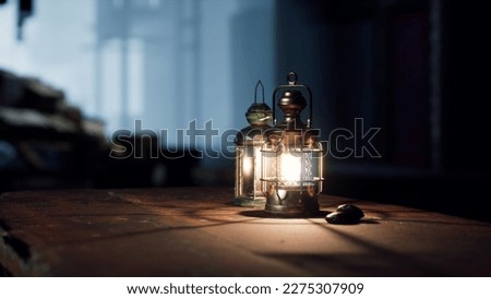 Ornamental Arabic lantern with burning candle glowing at night and glittering golden bokeh lights. Festive greeting card, invitation for Muslim holy month Ramadan Kareem. dates on table.