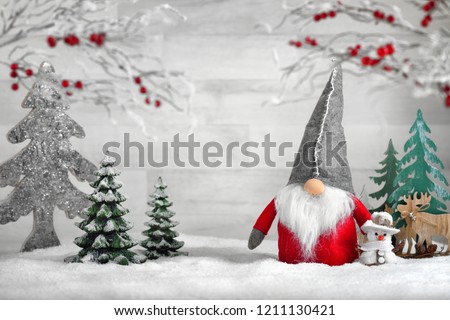 Ornamental arrangement for winter and Christmas, with a Santa puppet 