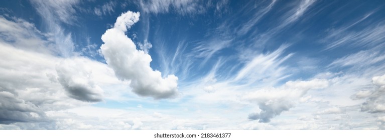 Ornamental clouds. Dramatic sky. Epic storm cloudscape. Soft sunlight. Panoramic image, texture, background, graphic resources, design, copy space. Meteorology, heaven, hope, peace concept