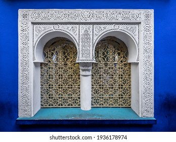 Ornamental muslim blue and white double window in Jardin Majorelle, Marrakech, Morocco
