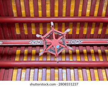 Ornamental structural beams of Imperial Palace painted in red and yellow color. Red symbolizes bravery and luck, in local beliefs combined with highly intricate engravings.