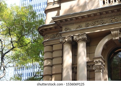 Ornate Architectural Sandstone Detail On The Facade Of The Sydney Town Hall Building. A Tree And Office Building In The Background. 483 George Street, Sydney