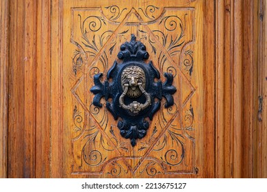 Ornate Carved Wooden Door With Ornate Black And Gold Metal Lion Door Knocker