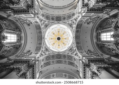 The ornate ceiling of a church interior, featuring a dome and intricate carvings. - Powered by Shutterstock