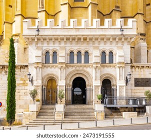 The ornate entrance of the Almudena Cathedral crypt in Madrid, featuring arched doorways, columns, and detailed stonework. - Powered by Shutterstock