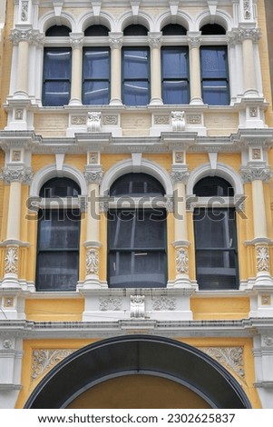 Ornate facade of AD 1903 erected building featuring Corinthian columns-dentil cornices-pilasters-string courses-round arch windows-plain keystones- timber windows-stucco details. Sydney-NSW-Australia.