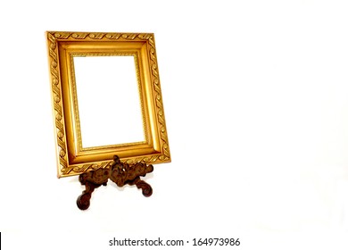 Ornate Gold Picture Frame On Vintage Metal Stand