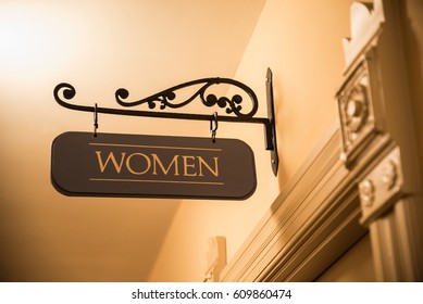 Ornate Interior Door Frame With Wrought Iron Women's Bathroom Sign