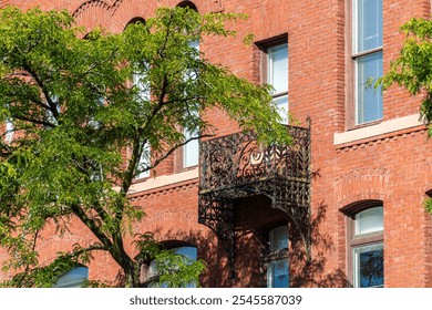 Ornate iron balcony on historic brick building facade in Brookline, Massachusetts, USA - Powered by Shutterstock