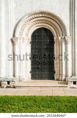 Ornate medieval church door showcases intricate stone carvings and reflects religious heritage and cultural design