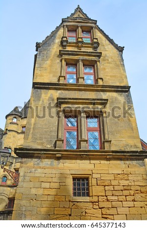 Ornate and narrow gable in a medieval house with leadlight windows