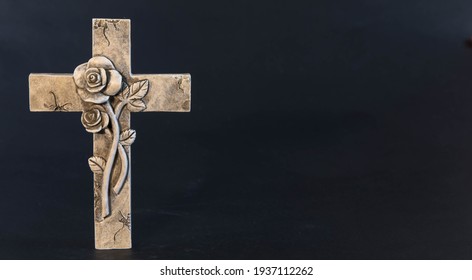 Ornate religious cross with a flower on a dark background.
Moment of grief at the end of a life. Last farewell. Copy space.
Obituary notice template