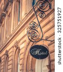 Ornate Sign For Luxury Hotel Outside Beautiful Sandstone Building