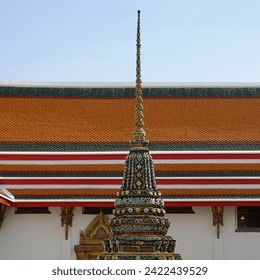 Ornate temple spire of a Thai temple, showcasing the exquisite mosaic and decorative craftsmanship.