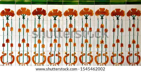 Ornate tiles decorated with tall red poppy like flowers. These are typical of the tiles found on the facade of traditional Chinese Peranakan shop houses.