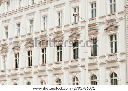 Ornate white classical building facade with rows of windows