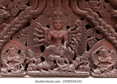 Ornate wood carving showing the hindu goddess durga riding a lion and battling the demon mahishasura, a popular subject in hindu mythology - Powered by Shutterstock