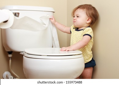 Ornery Baby Pulling Toilet Paper Off The Roll