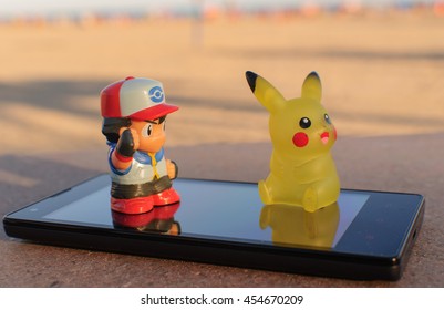 OROPESA DEL MAR - JULY 2016: Pokemon Go Pikachu And Ash Ketchum Real With A Smartphone