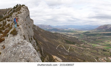 Orpierre, Hautes Alpes-Drome, France -   09-04-2022: panoramic view of a rockclimber standing on top of Quiquillon, a part of the climbing area of Orpierre South of France                        
