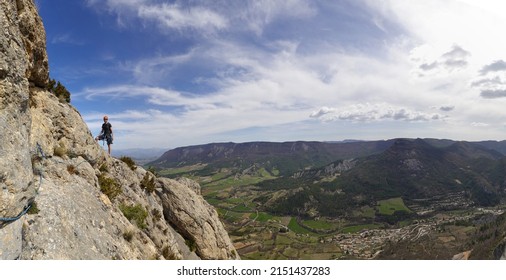 Orpierre, Hautes Alpes-Drome, France,  12-04-22: Panoramic view of a rock climber standing on top of l'Adreche, a part of the climbing area of Orpierre, South of France                              