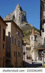 Orpierre, Hautes Alpes-Drome, France: 14-04-2022: Rocher de Quiquillon' towering high above the church of the village of Orpierre, South of France