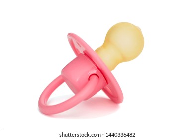 Orthodontic pacifier isolated on a white. Pink baby's pacifier isolated on white background.