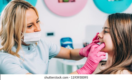 Orthodontist Fixing Girl’s Dental Braces