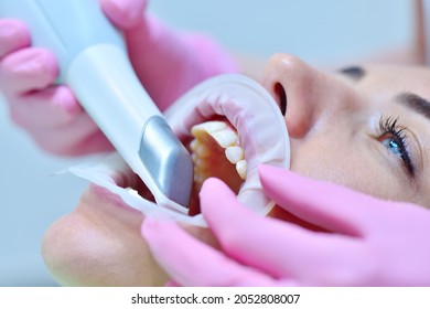 Orthodontist using 3D intraoral scanner for scanning teeth patient's. Modern dental clinic with equipment.  Dentistry and health care concept. Close up