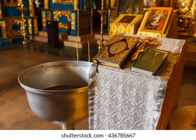 Orthodox baptism bowl of holy water and candles. Russia