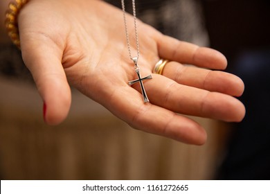 Orthodox christenings of a child, a cross in his father's hand