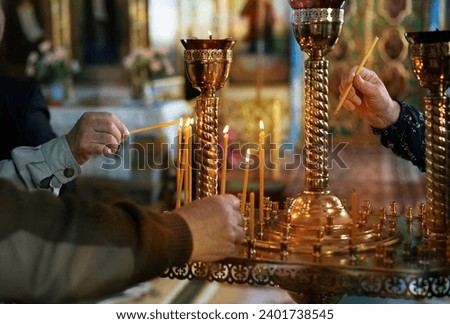 Orthodox Church. Parishioners lighting and placing candles. Candles are lit for repose.