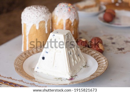 Orthodox Easter. Easter cakes, Easter Ortodox curd cake and colored eggs on table. Side view