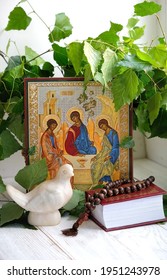 orthodox icon of Holy Trinity, dove, rosary beads, birch leaves, bible books. Holy Trinity Sunday. festive traditional composition for Pentecost day