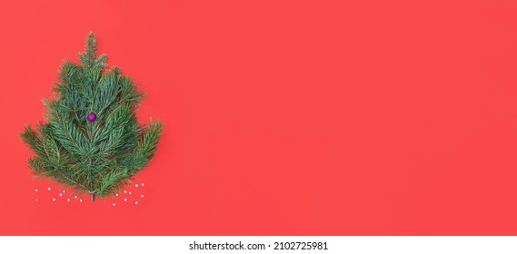 Orthodox New Year´s greeting card made of pine tree branches and decoration ball. Minimal flat lay composition on red background, banner with copy space - Powered by Shutterstock