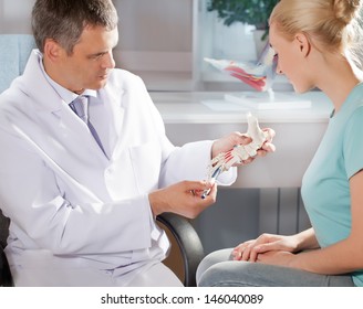 Orthopedic Doctor In His Office With The Model Of The Feet