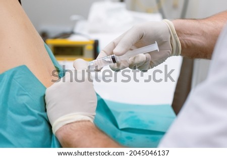 Orthopedic doctor injecting cortisone in slipped disc