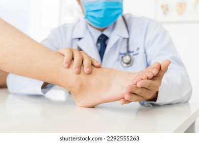 The orthopedic doctor or surgeon in white gown examined the patient with foot pain problem.White clean table or bed with blur background.Hallux or bunion with transfer metatarsalgia.Orthopaedic unit. - Shutterstock ID 2292555263