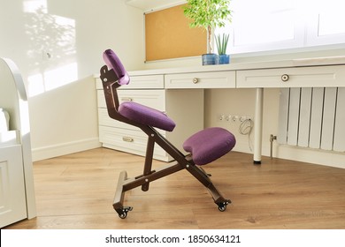 Orthopedic ergonomic kneeling chair in the interior of children's room, home office. Taking care of your back health, healthy lifestyle