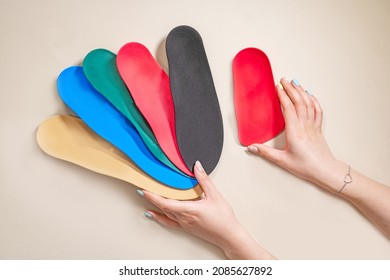 Orthopedic insoles for shoes on a colour background