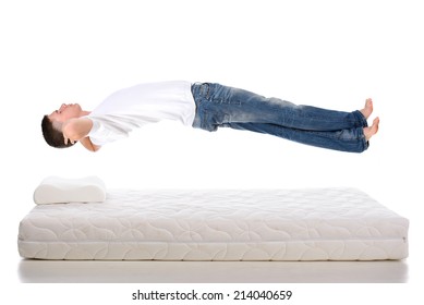 Orthopedic Mattress. A Young Man Sleeping On A Mattress, Side View. Flying During Sleep Isolated On White Background