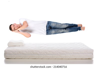 Orthopedic Mattress. A Young Man Sleeping On A Mattress, Side View. Flying During Sleep Isolated On White Background