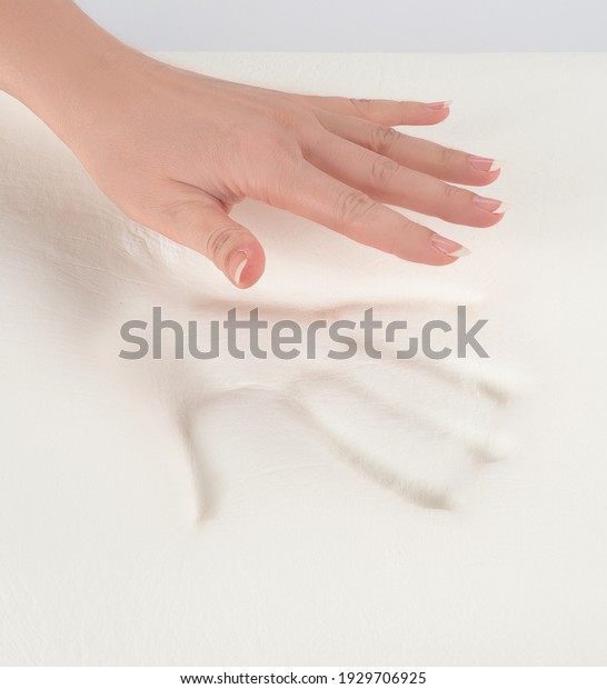 Orthopedic pillow, memory foam. Handprint on\
the pillow. Comfortable bedding with orthopedic, therapeutic\
effect. Memory foam\
material.