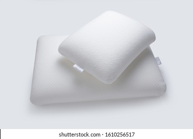 Orthopedic pillows, memory foam on white background. Two pillows piled against white background. Comfortable pillow with orthopaedic, therapeutic effect