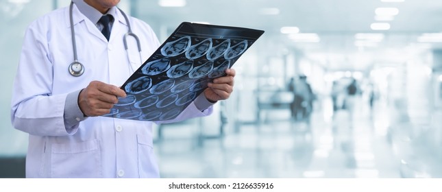 Orthopedic Surgeon Doctor Examining Patient's Knee Joint X-ray Films, MRI Bone, Ct Scan At Radiology Orthopedic Unit In Hospital. Knee Joint Film X Ray, Close Up, Healthcare Medical Technology Concept