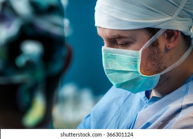 Orthopedic Surgeon In The Operating Room Focusing On His Work.