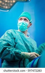 Orthopedic Surgeon Portrait In The Hospital While Performing Keyhole Arthroscopic Surgery On Human Patient As Definitive Treatment Option.